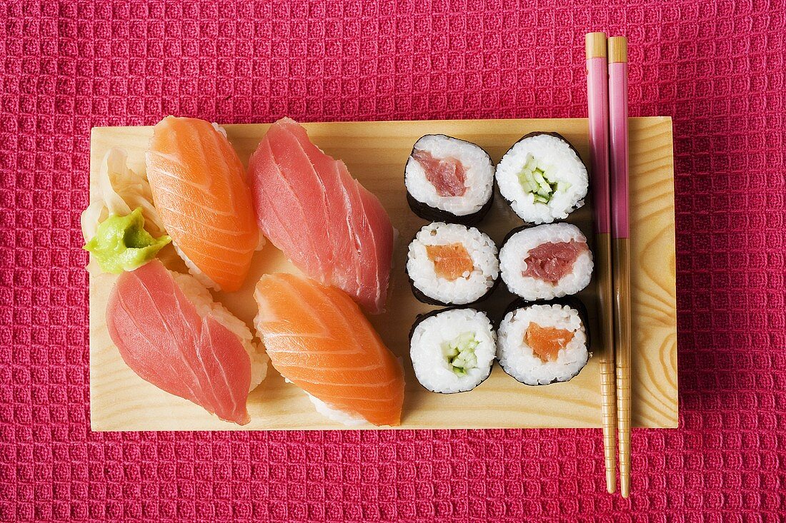 Nigiri sushi and maki sushi on sushi board
