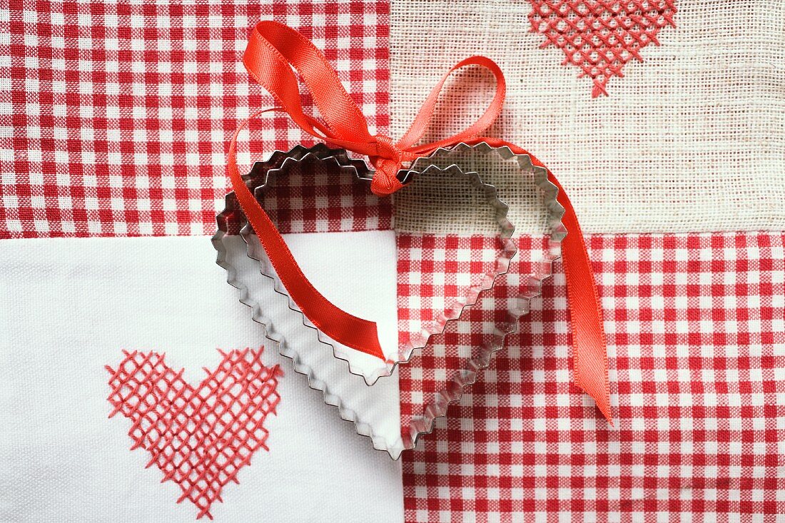 Heart-shaped biscuits with red gift ribbon