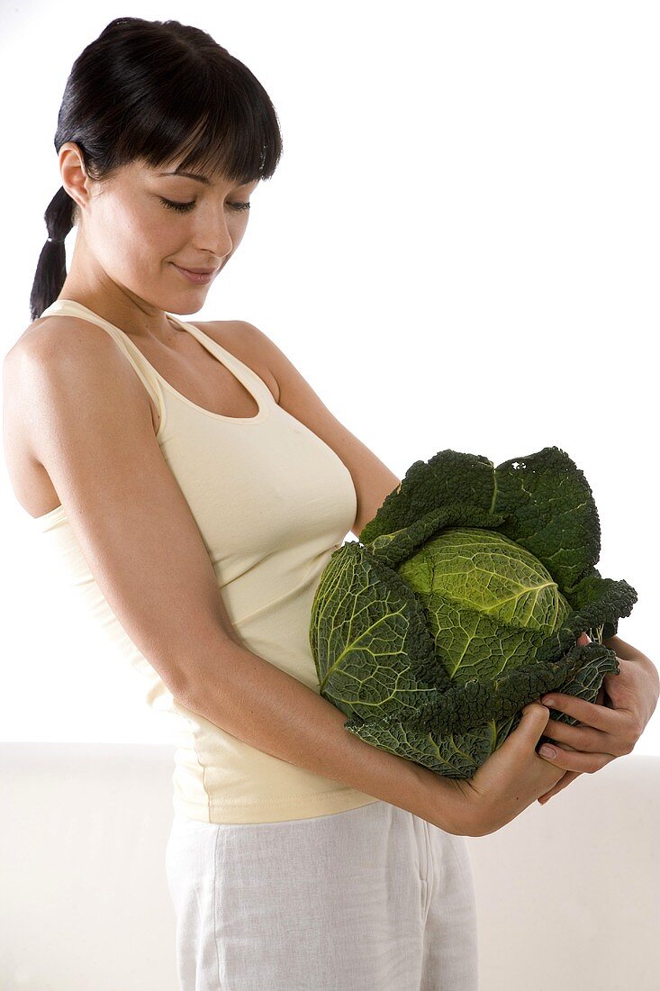 Young woman with a savoy cabbage