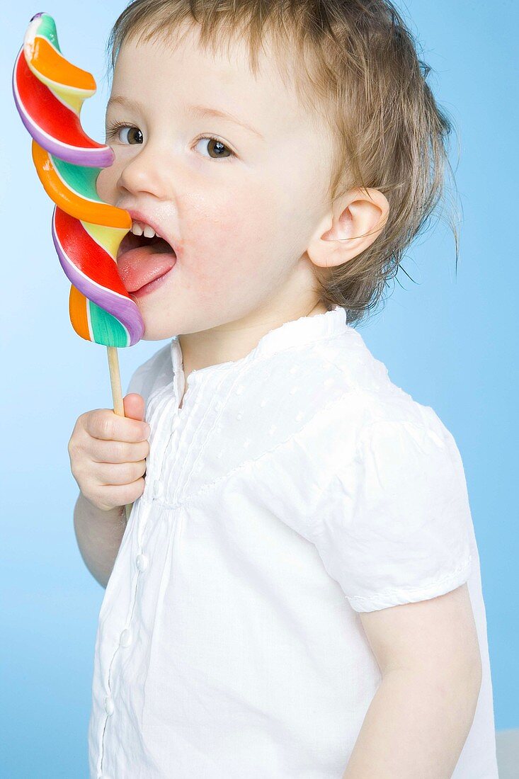 Small girl with a coloured lollipop