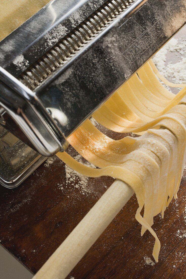 Tagliatelle coming out of pasta maker
