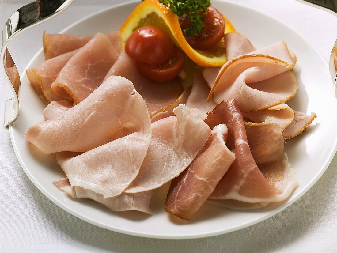 Various types of ham on a plate