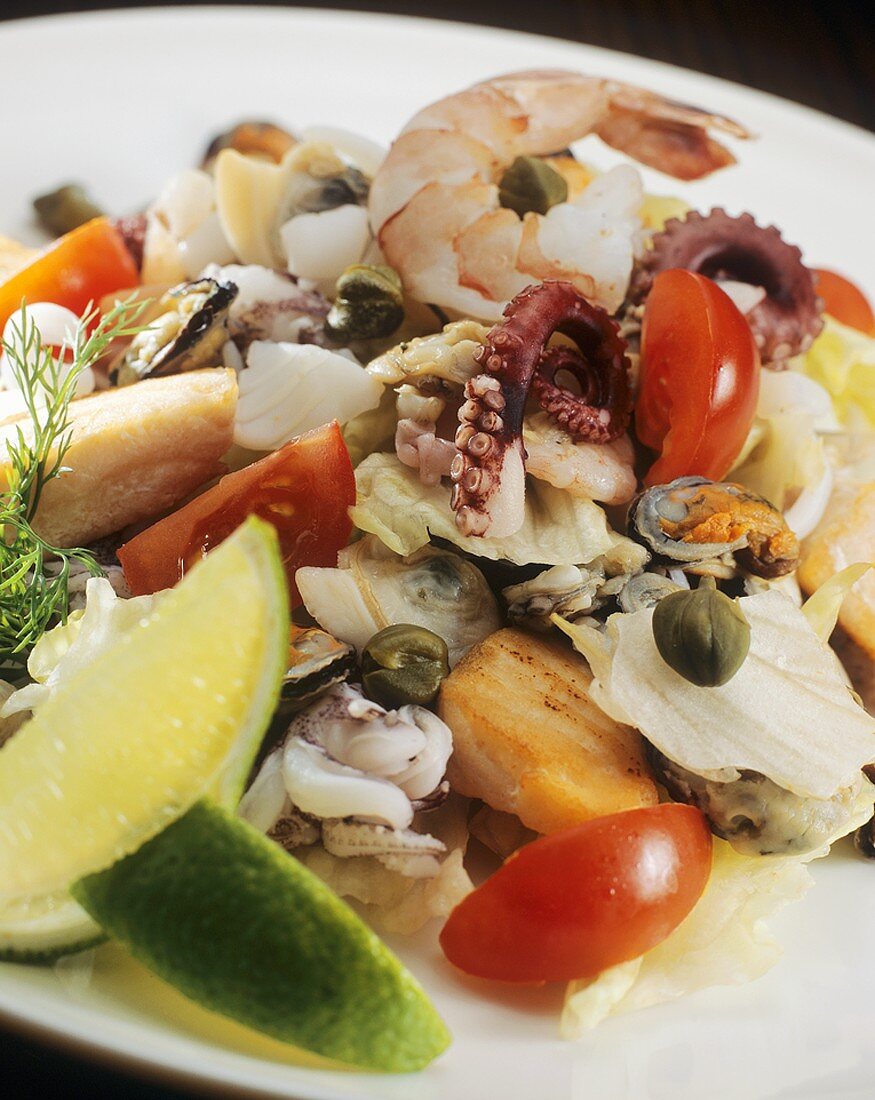 Seafood salad with lime wedges