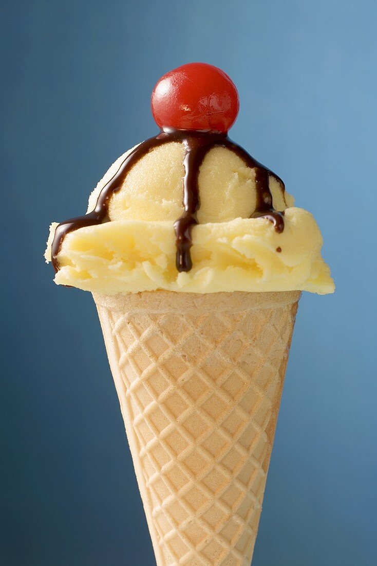 Vanilla ice cream cone with chocolate sauce & cocktail cherry