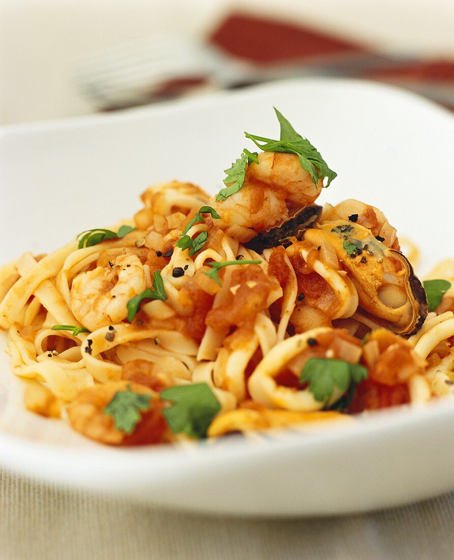 Noodles with seafood and tomato sauce