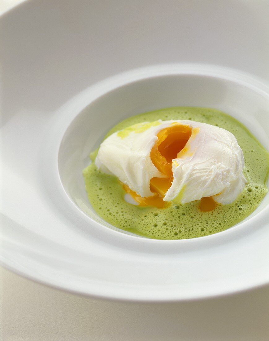 Herb foam soup with poached egg