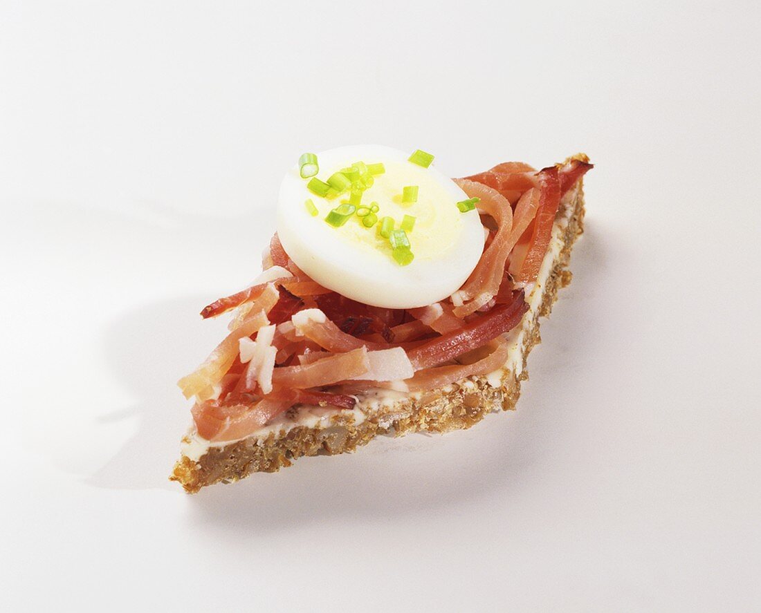 Canapé: strips of bacon & slice of egg on wholegrain bread