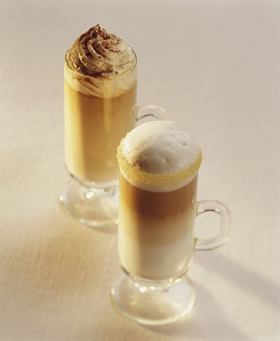 Latte macchiato and milky coffee with cream topping
