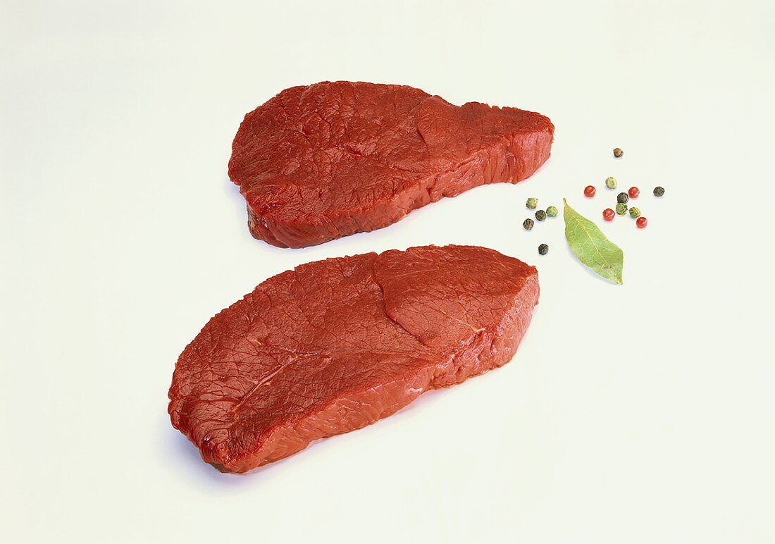 Two beef steaks, peppercorns, bay leaf