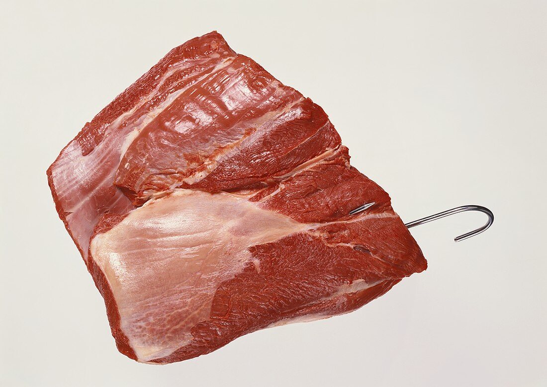 A piece of beef on a meat hook