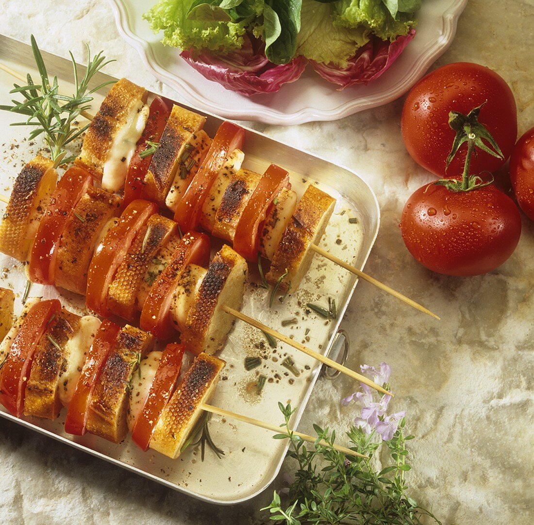 Tomato and mozzarella on skewers with baguette slices