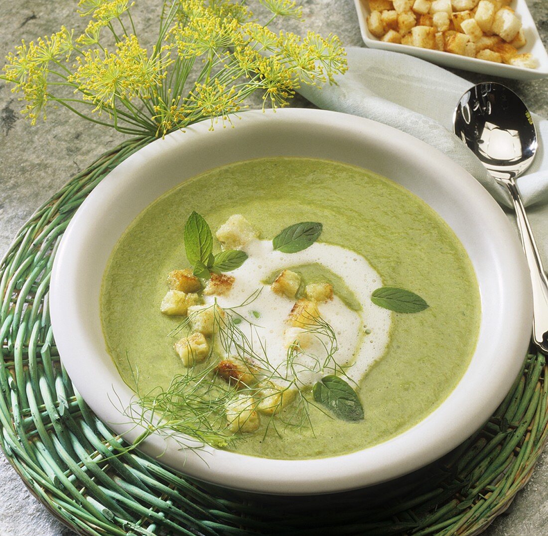 Vegetable cream soup with sour cream, croutons and herbs