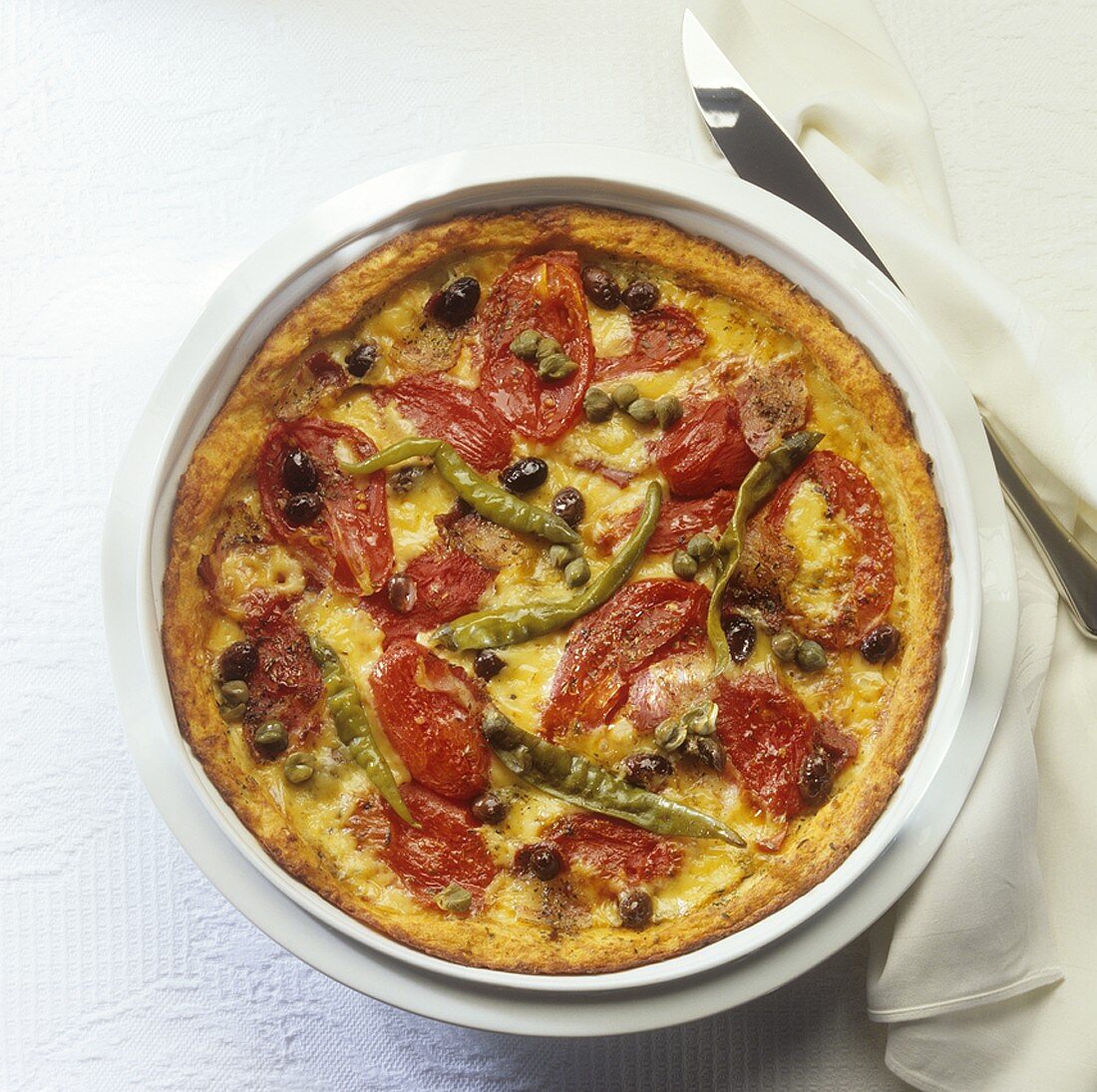 Potato pizza topped with tomatoes, capers and chillies