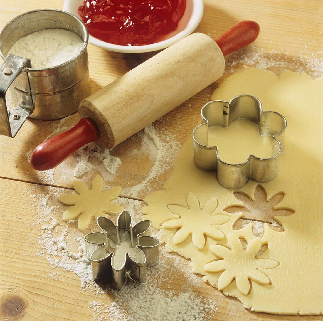 Baking scene with pastry, biscuit cutters, rolling pin