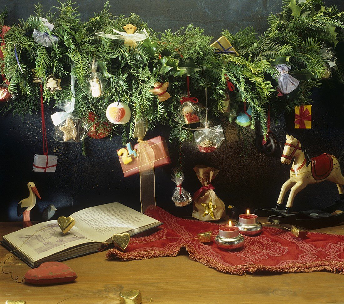 Advent calendar with sweets on garland of fir branches