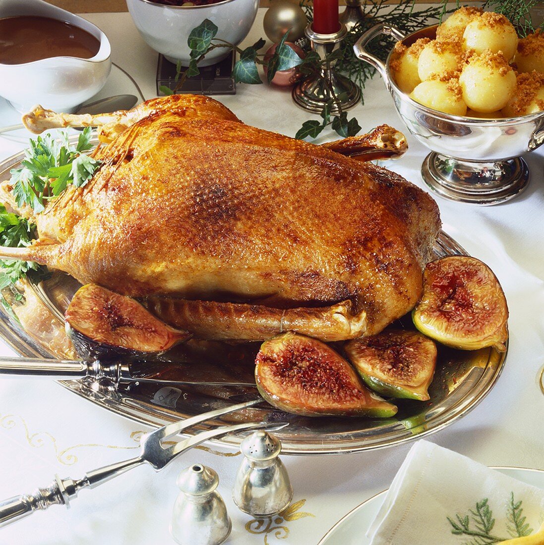 Roast goose with figs on festive table