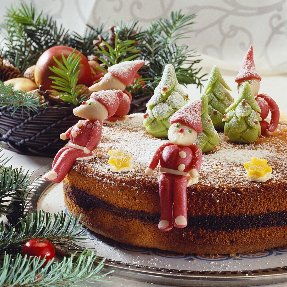 Poppy seed cake decorated with Christmassy marzipan figures