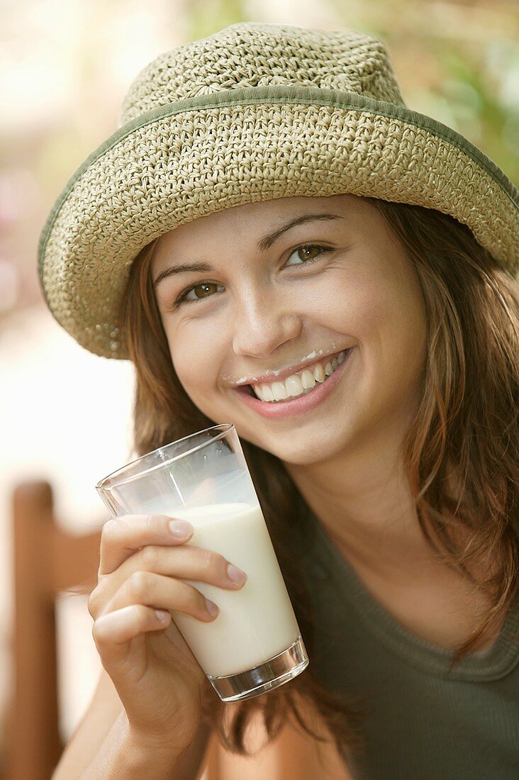 Young woman with milk around her mouth