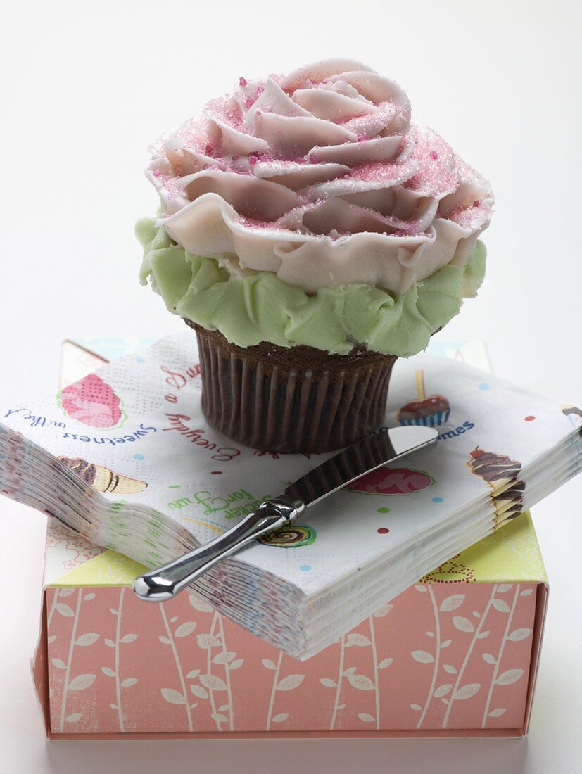 A cupcake on a pile of napkins