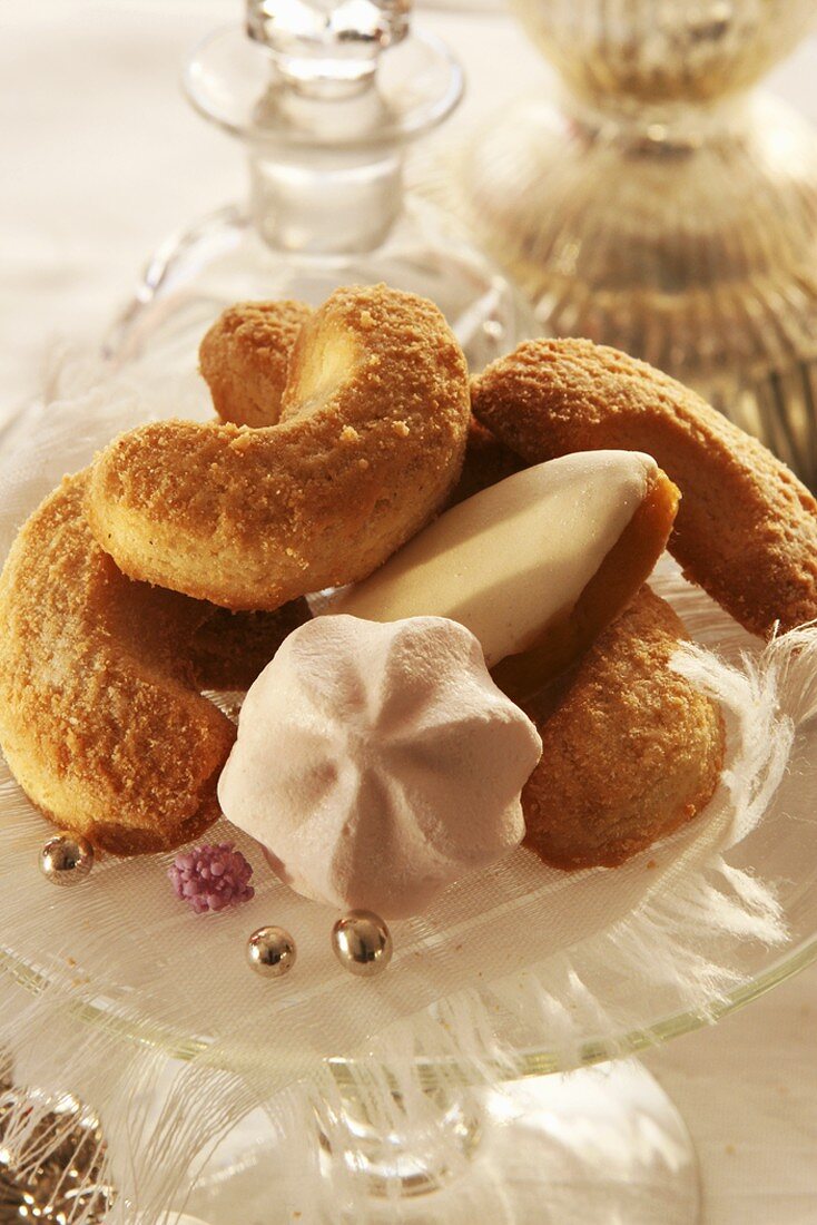 Biscuits (vanilla crescents, meringues) on glass stand