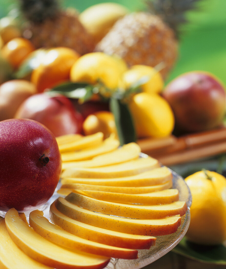 Sliced mango with a basket of fruit