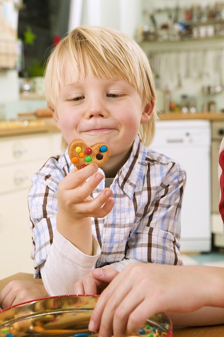 Boy holding a biscuit