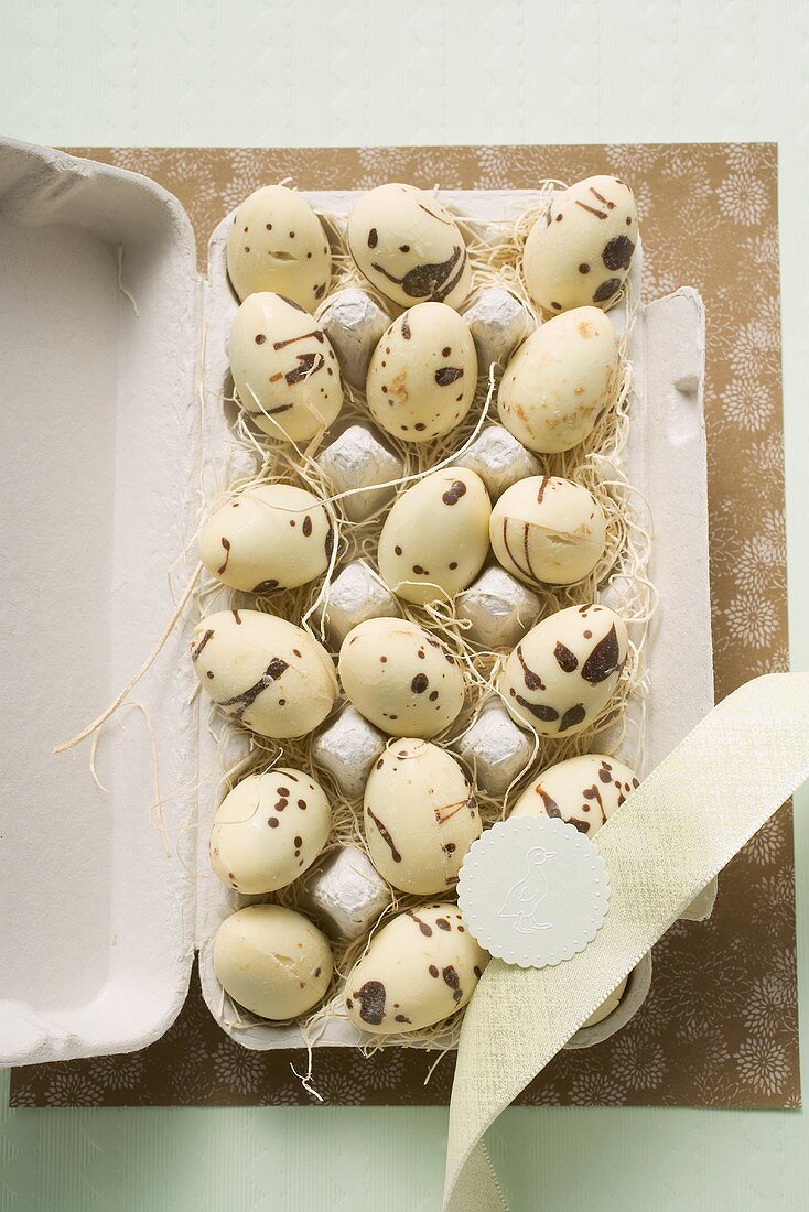 Speckled chocolate eggs in an egg box