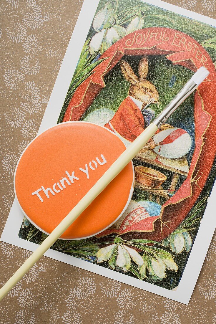 A biscuit with the words 'Thank you' and an Easter card