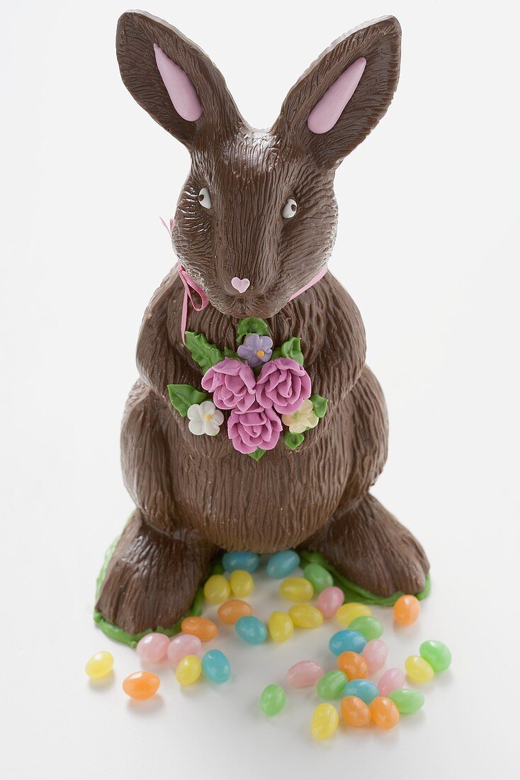 A chocolate Easter Bunny with colourful Easter sweets