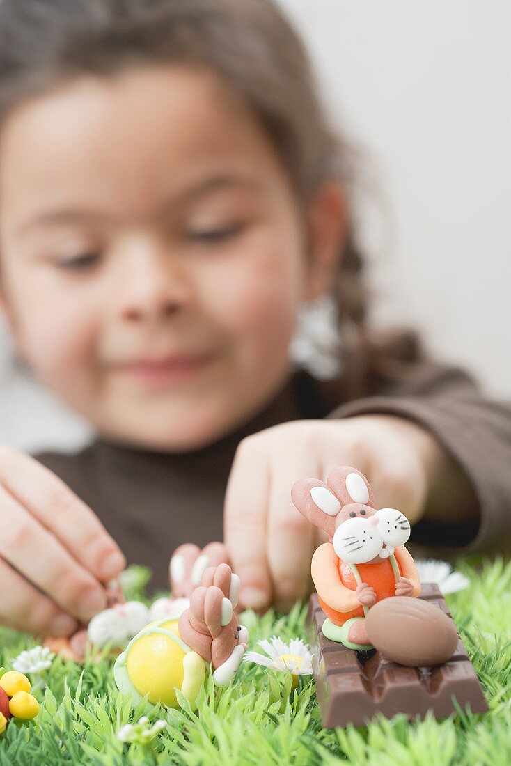A girl playing with chocolate figures