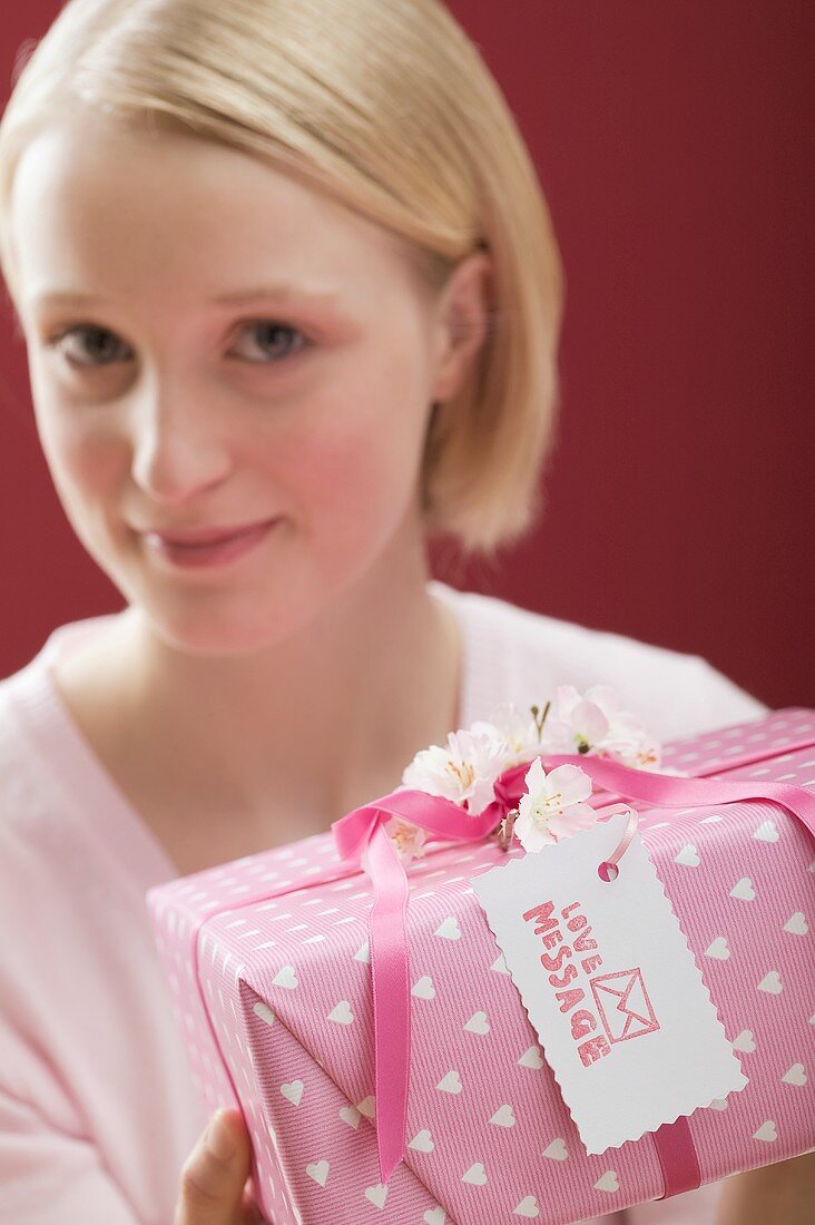 Young woman with a gift for Valentine's Day