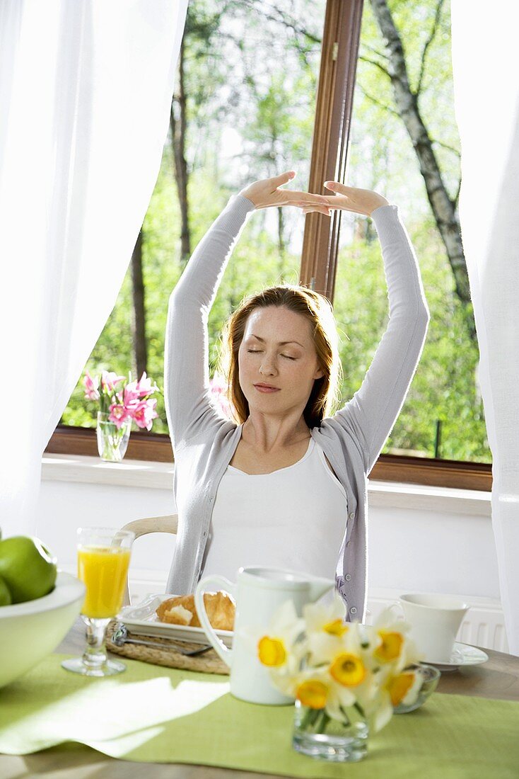 Young woman sitting at breakfast table