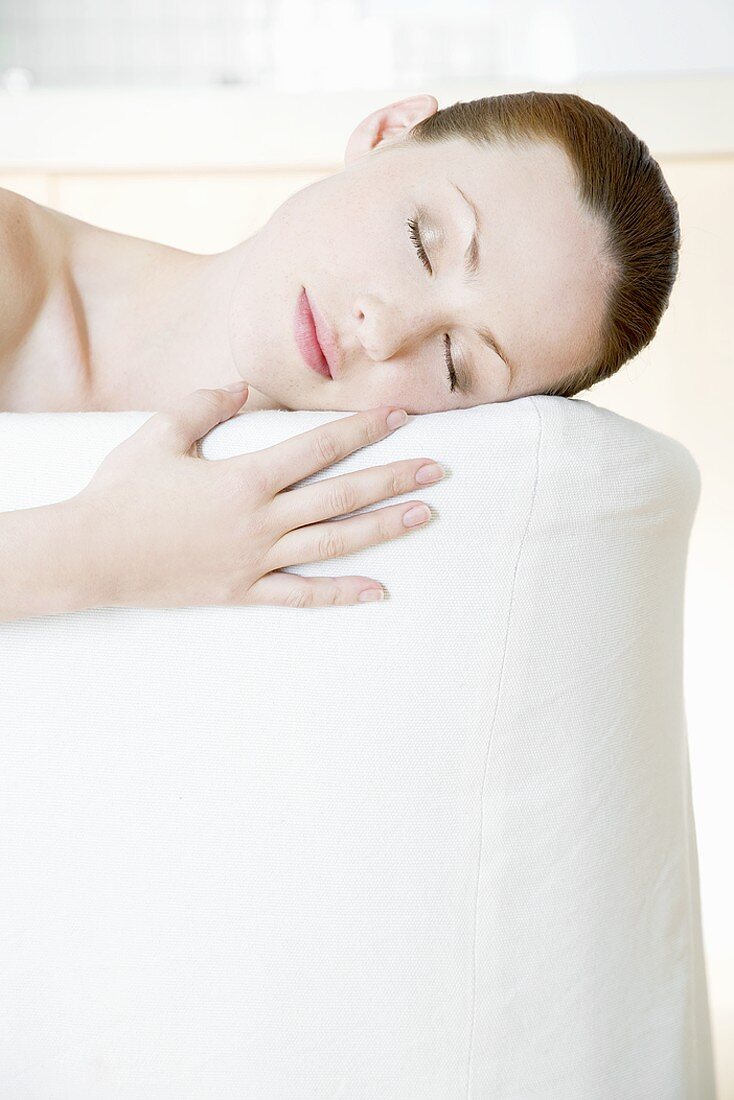 Young woman asleep on a sofa