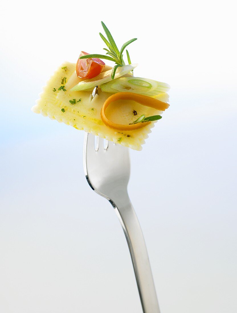 Ravioli with vegetables on fork