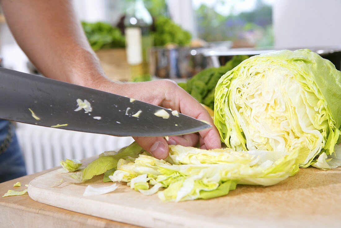 Cutting iceberg lettuce into bite-sized pieces