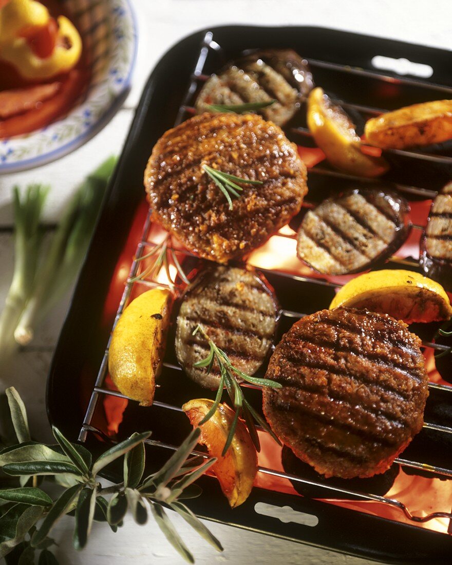 Grilled burgers, aubergines and lemons