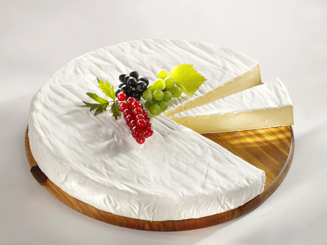A wheel of Brie with pieces removed