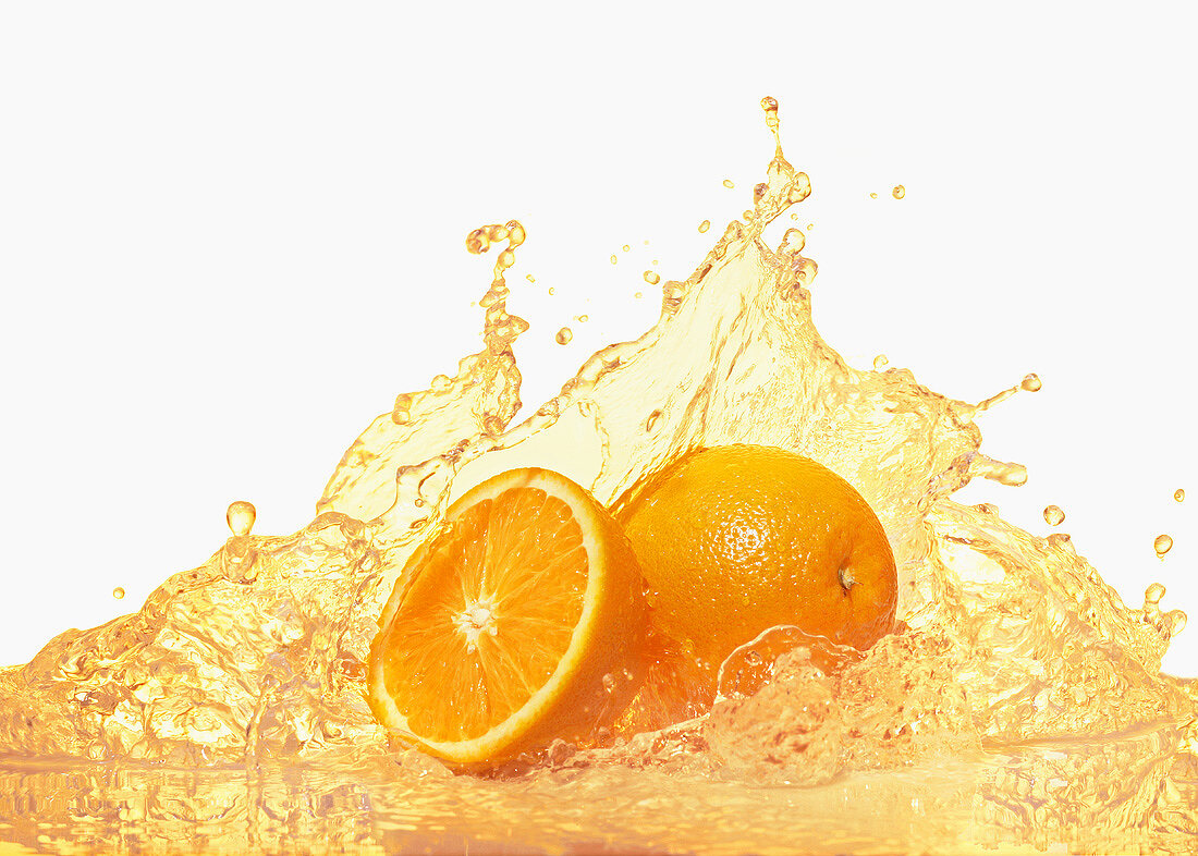 Oranges with splashing orange juice