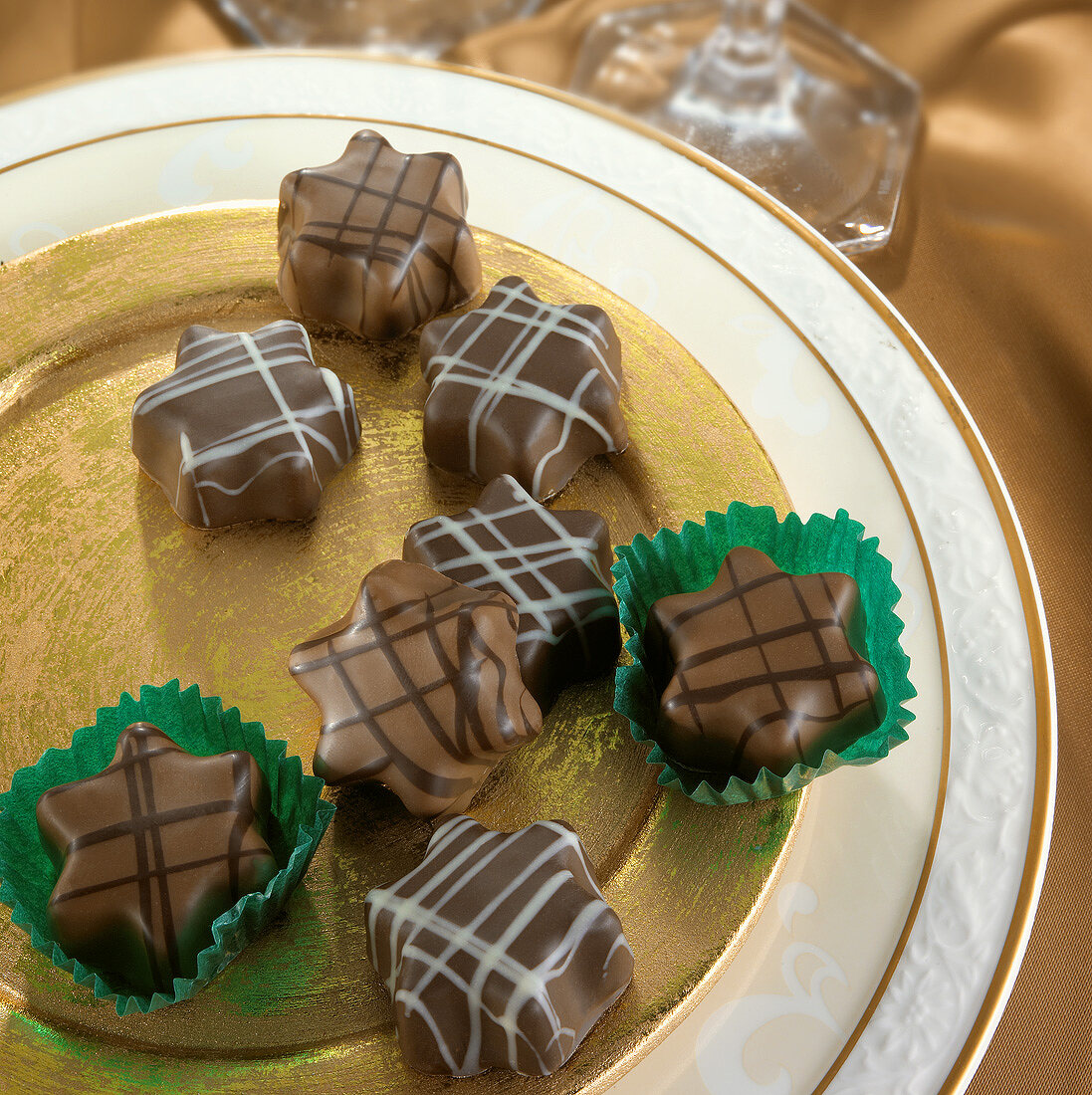 Star-shaped organic chocolates on a gold plate