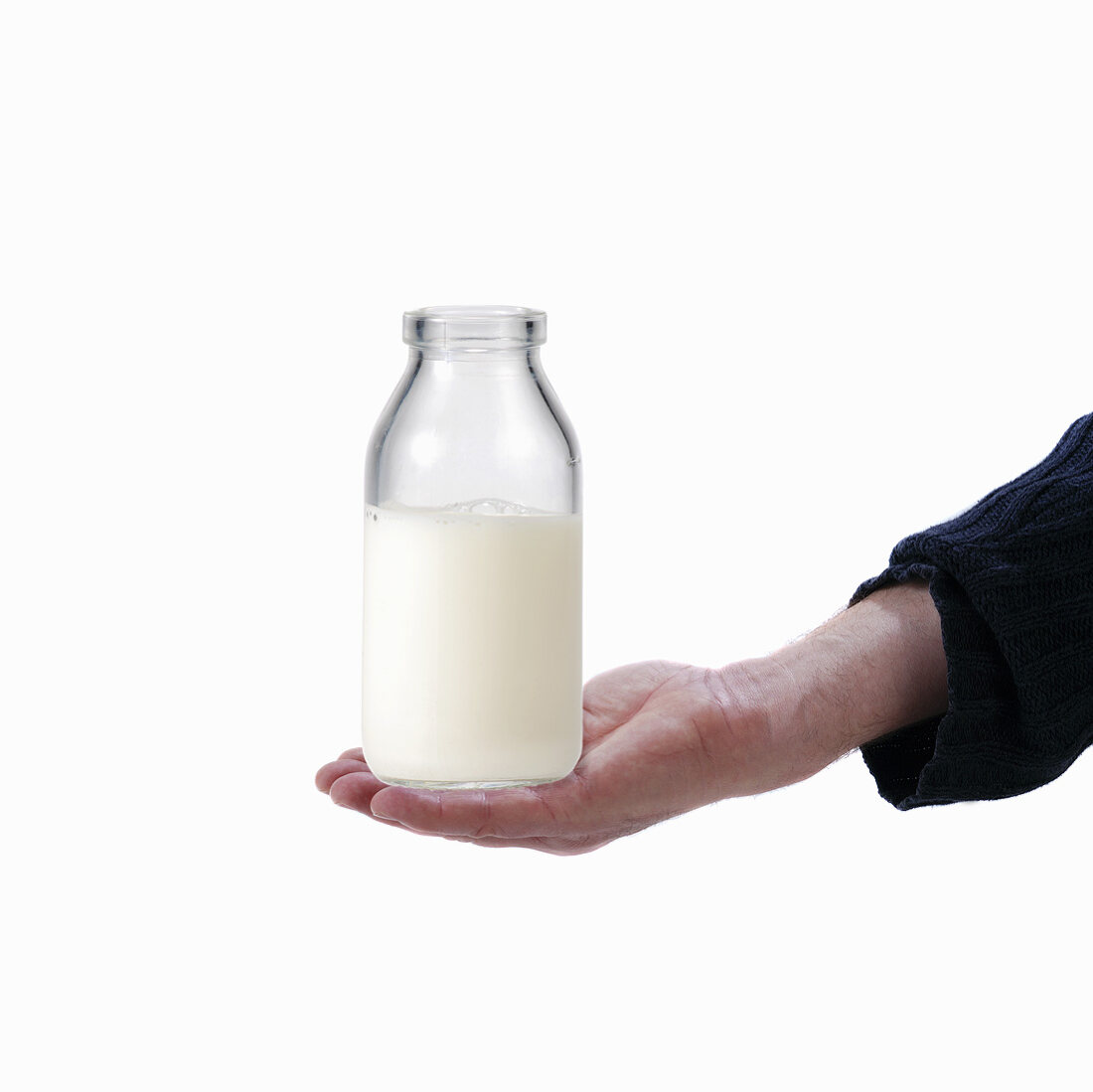 Hand hält eine Milchflasche
