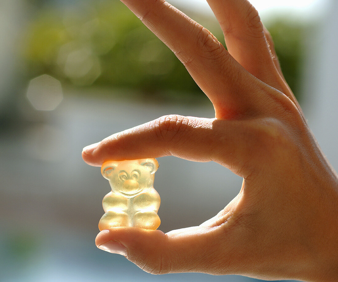 Hand holding a gummi bear