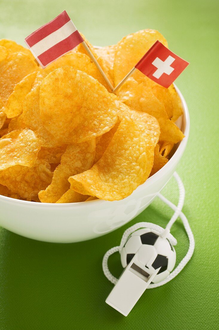 Crisps, flags of Austria and Switzerland and whistle