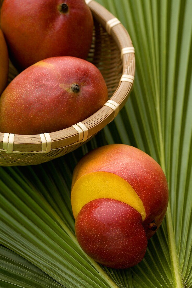 Mangos in basket and on palm leaf
