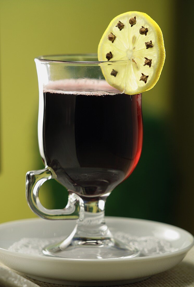 Mulled wine with clove-studded slice of lemon