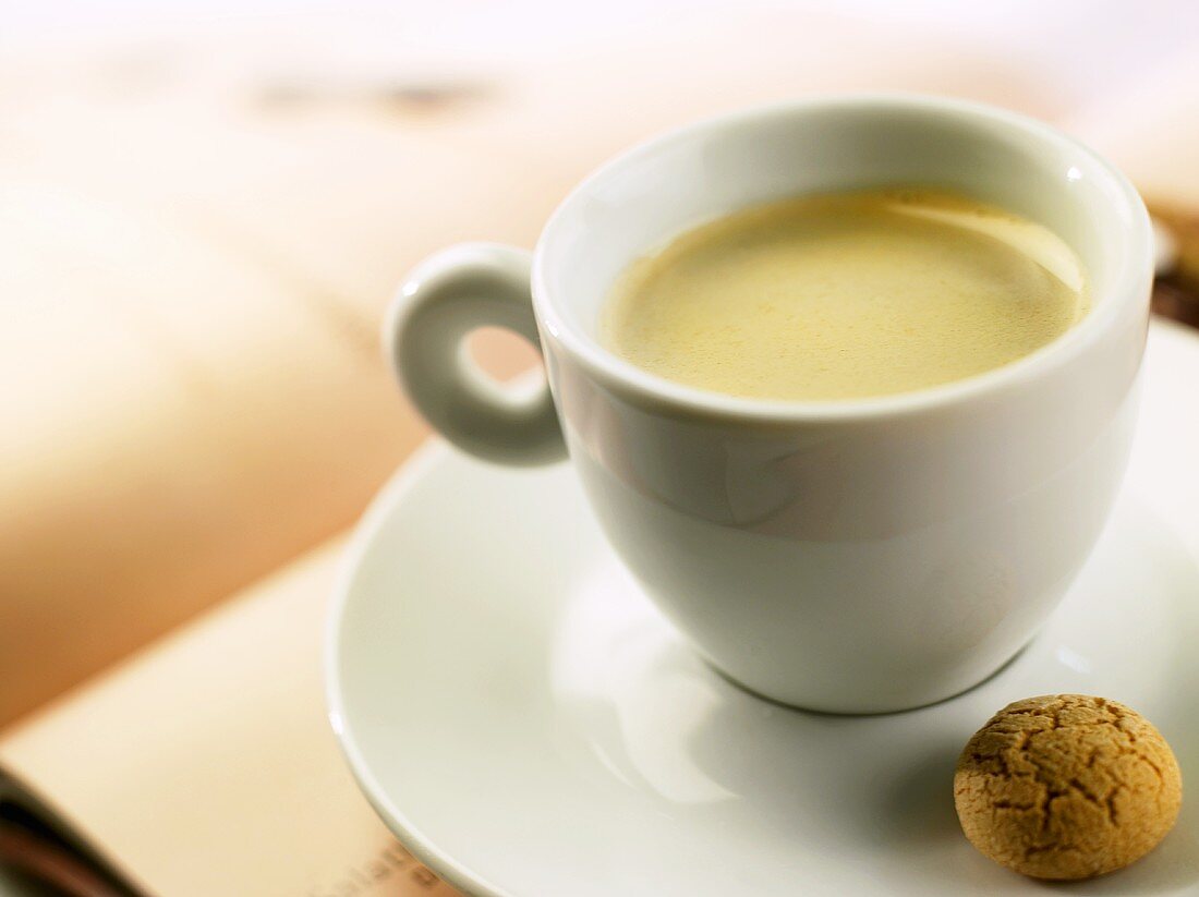 A cup of espresso with almond biscuit