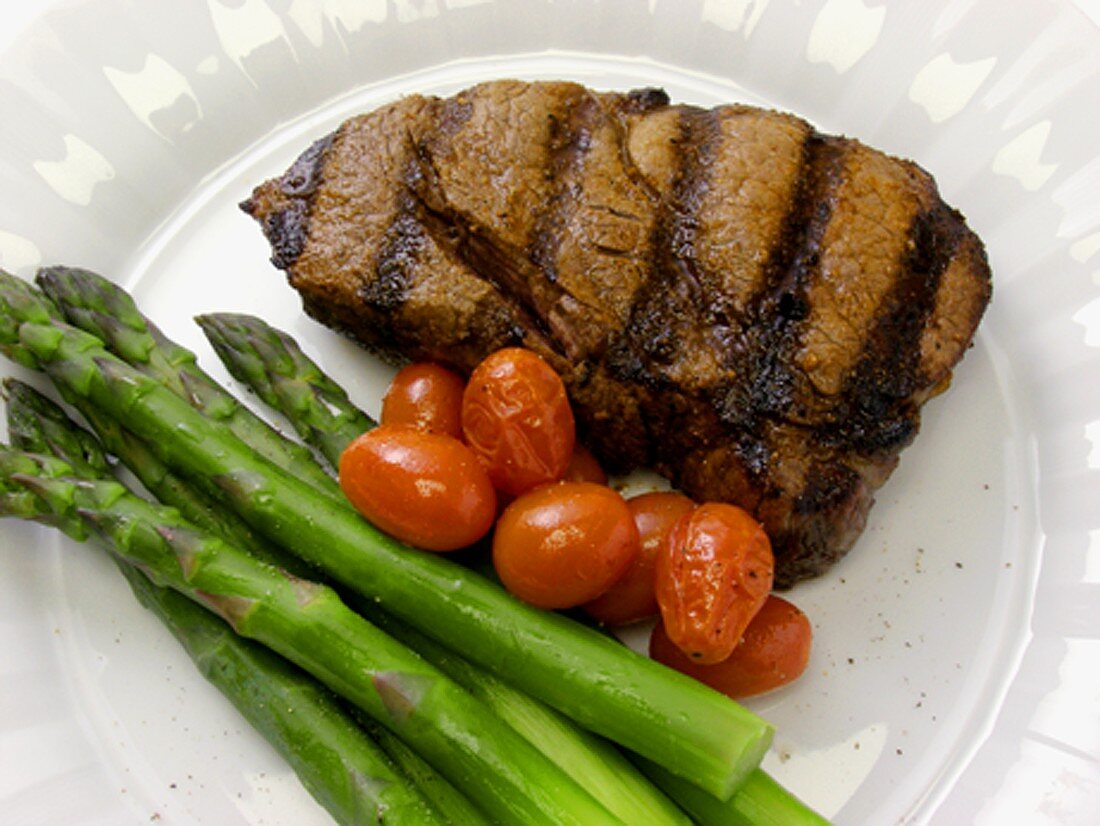 Gegrilltes Ribeye Steak mit Spargel und Kirschtomaten