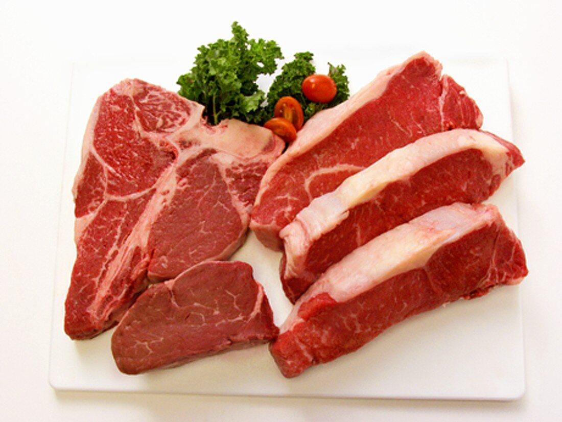 Beef steaks on chopping board