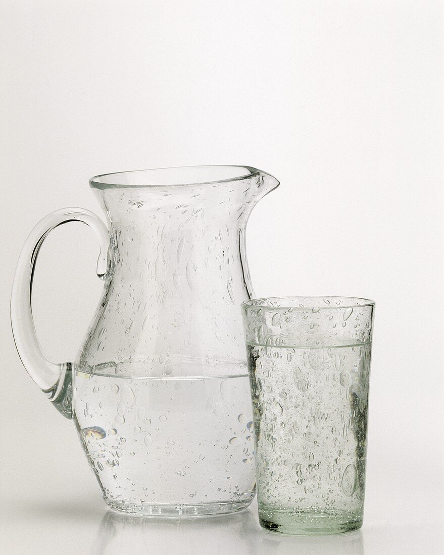 A glass of mineral water and jug