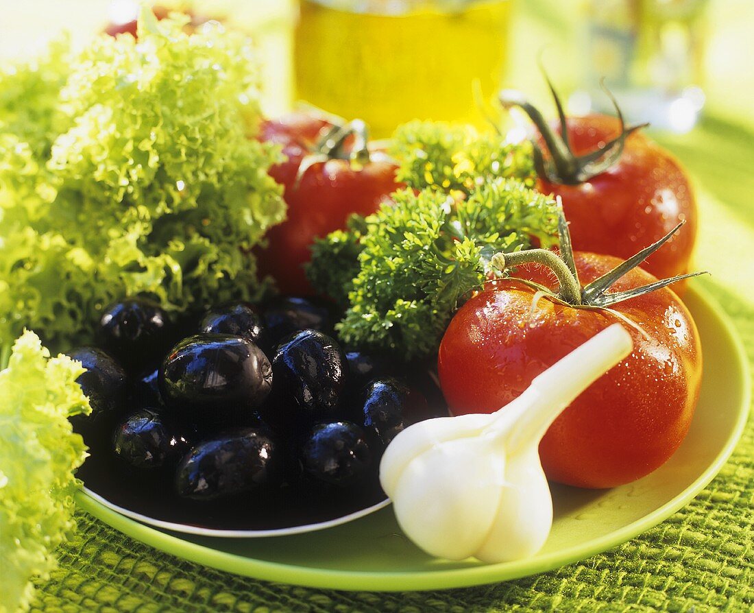 Salad ingredients: tomatoes, garlic, olives & Lollo Biondo
