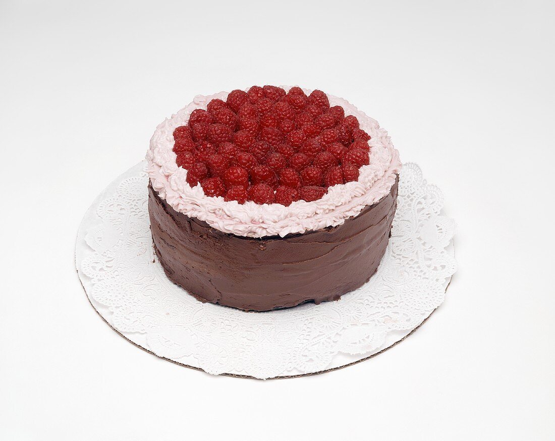 Chocolate cake with raspberries on doily